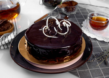 Торт «Прага со сливками» - шоколадный бисквит, крем сливочно-шоколадный, покрыт темным шоколадом и оформлен шоколадной глазурью.